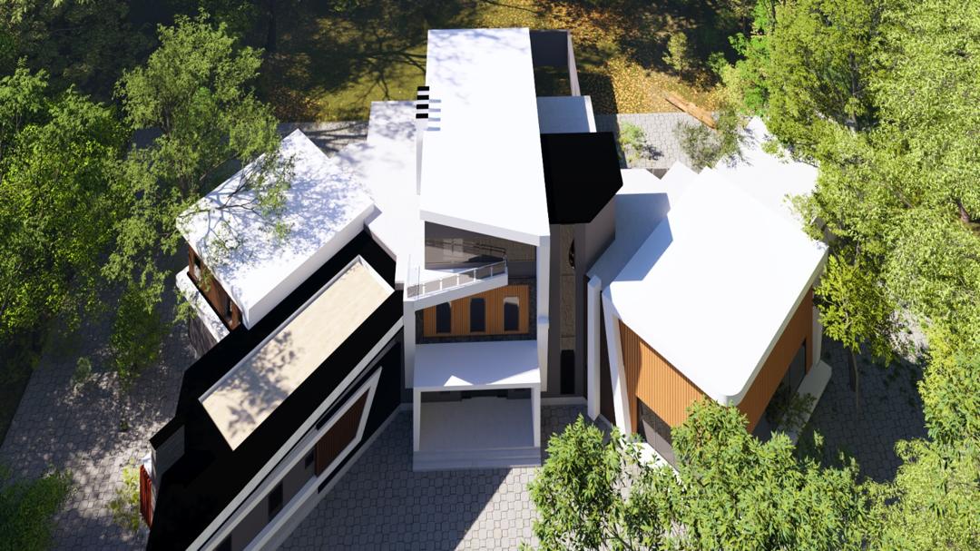 Aerial view of an Oakacers villa estate, its white and black angular roofs nestled among mature trees